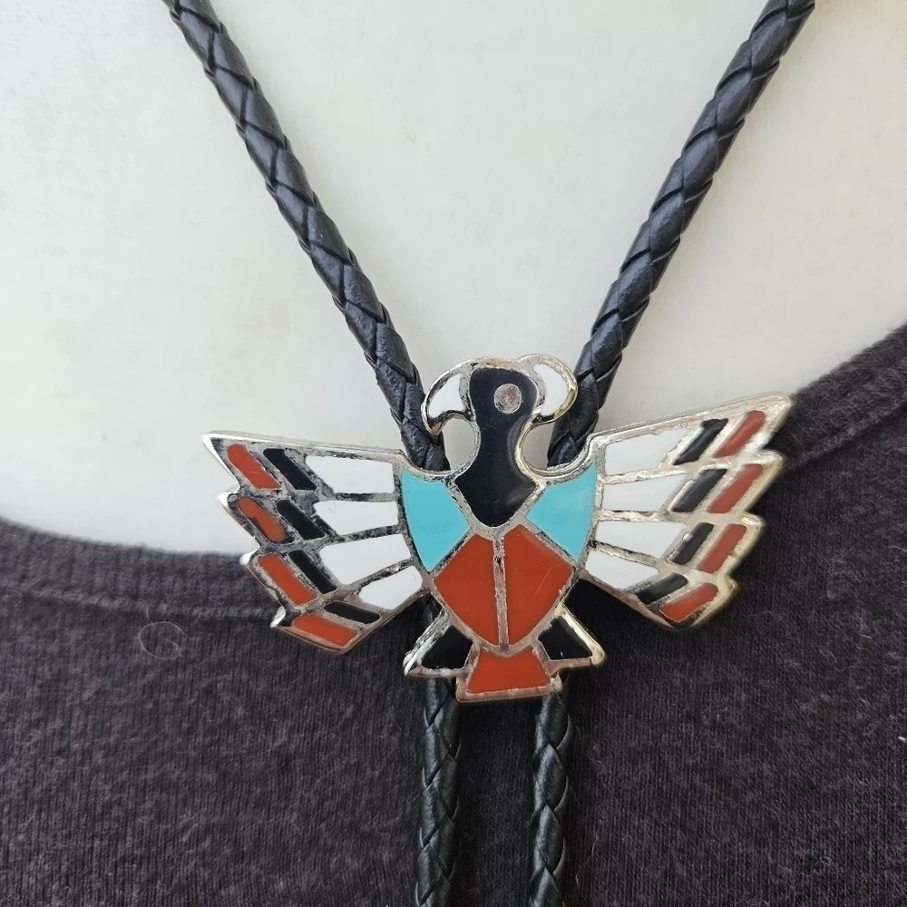 silver tone enamel thunderbird bolo tie on black leather cord